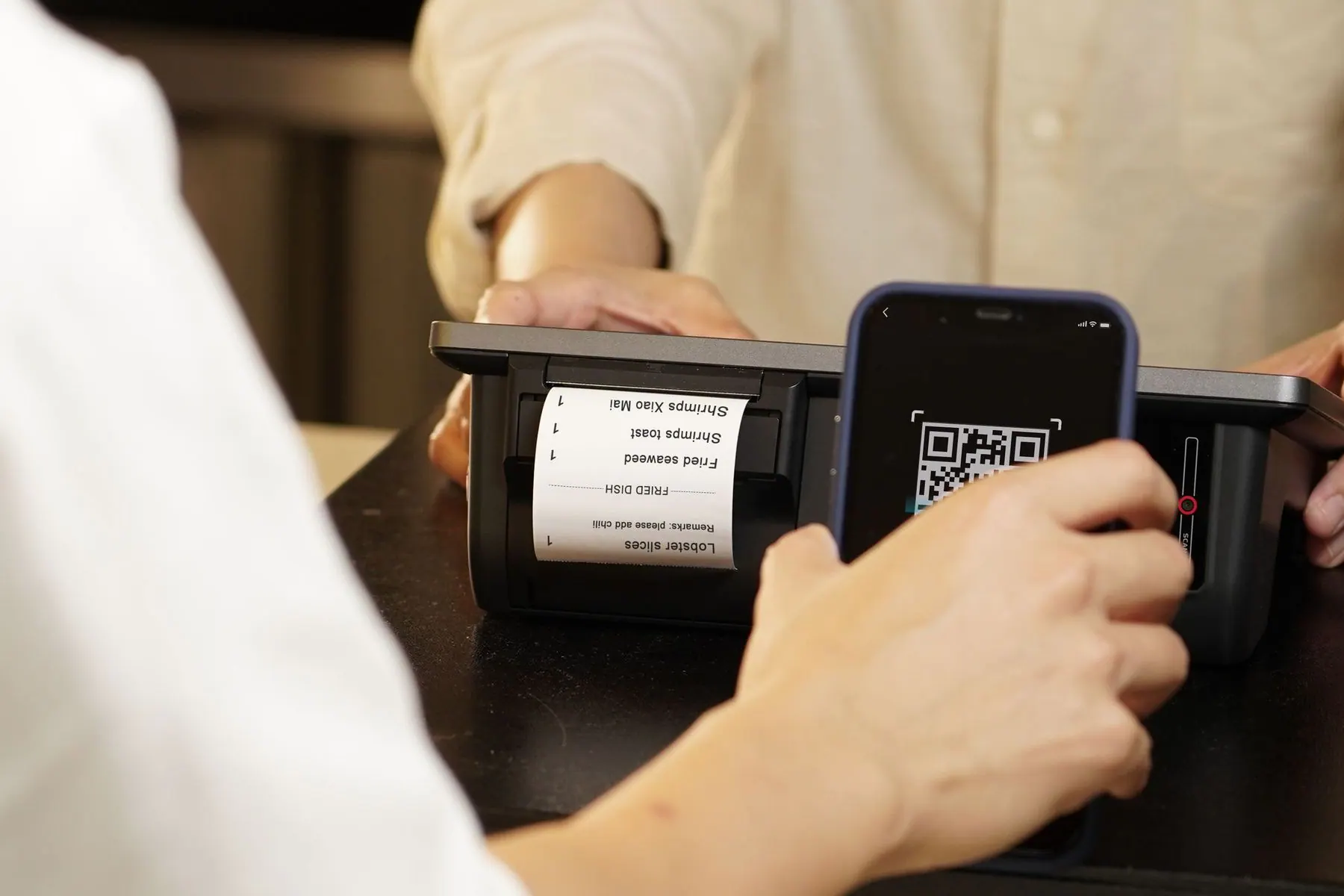 Close view of a traveler using a QR payment code at checkout